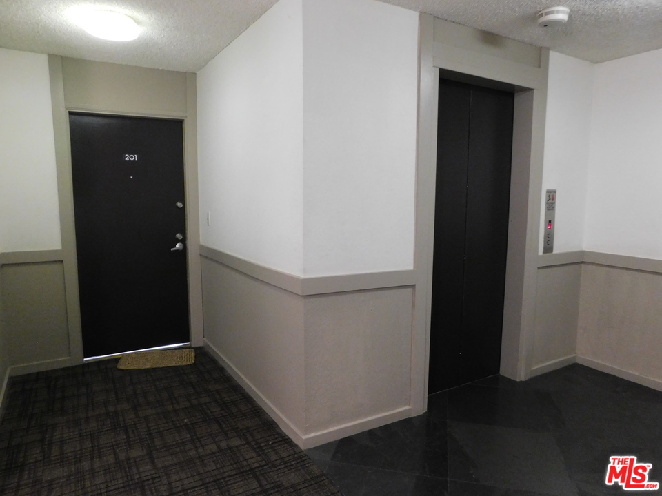 740 North Kings Road, Unit 201 Los Angeles, CA 90069 - Photo 20 of 20 an empty room with wooden floor