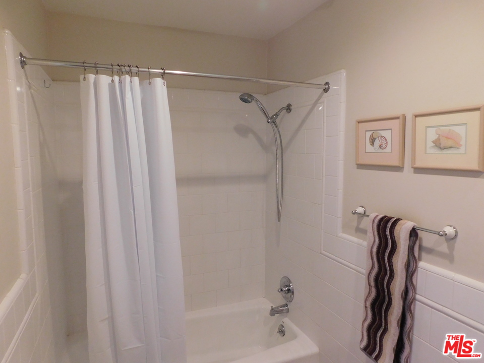 740 North Kings Road, Unit 201 Los Angeles, CA 90069 - Photo 3 of 20 a bathroom with a shower and a tub