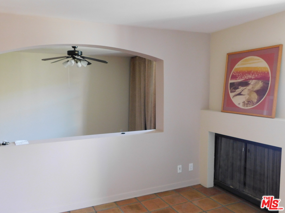740 North Kings Road, Unit 201 Los Angeles, CA 90069 - Photo 5 of 20 an empty room with a ceiling fan and a window
