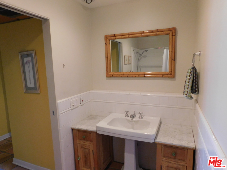 740 North Kings Road, Unit 201 Los Angeles, CA 90069 - Photo 6 of 20 a bathroom with a sink a mirror and vanity