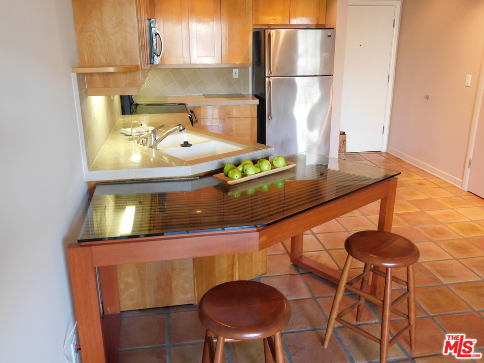 740 North Kings Road, Unit 201 Los Angeles, CA 90069 - Photo 7 of 20 a kitchen with a sink cabinets and window