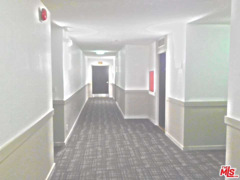 740 North Kings Road, Unit 201 Los Angeles, CA 90069 - Photo 10 of 20 a view of a hallway with wooden floor and staircase