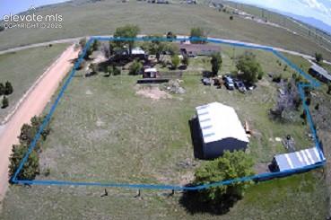 10970 Garrett Road Peyton, CO 80831 - Photo 50 of 50 a backyard of a house with outdoor seating