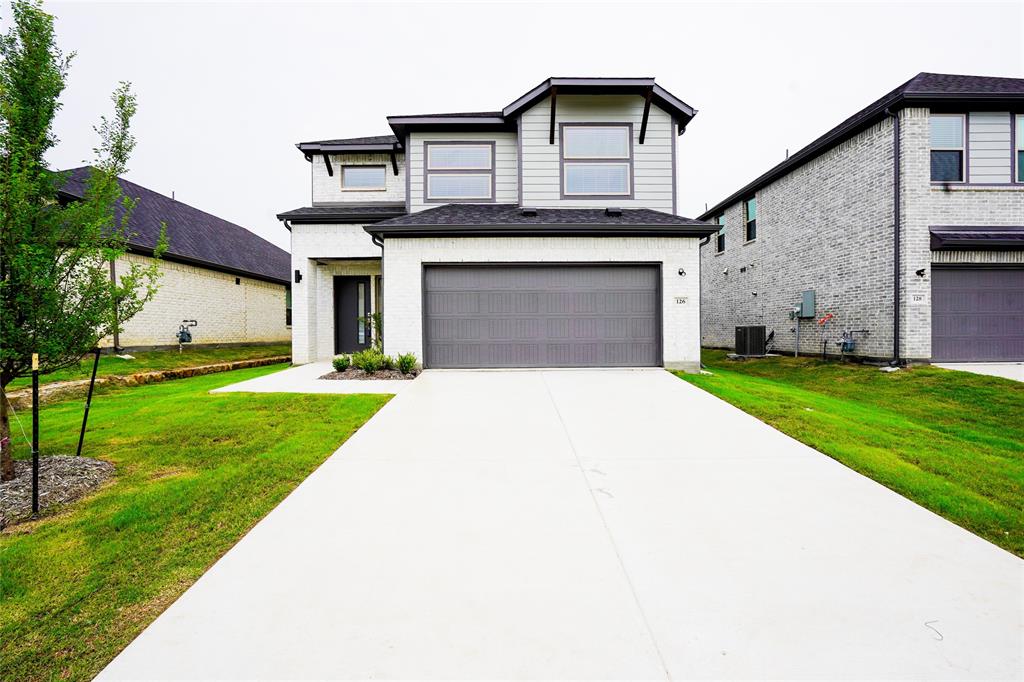 126 Huckleberry Road Forney, TX 75126 - Photo 1 of 1 a front view of a house with a yard and trees