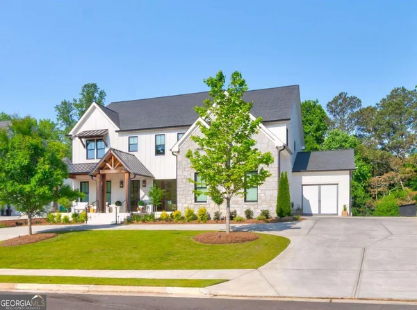 a front view of a house with garden