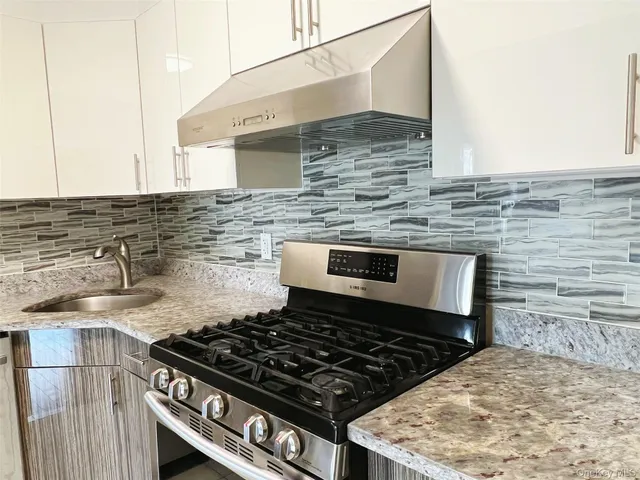 a stove top oven sitting inside of a kitchen