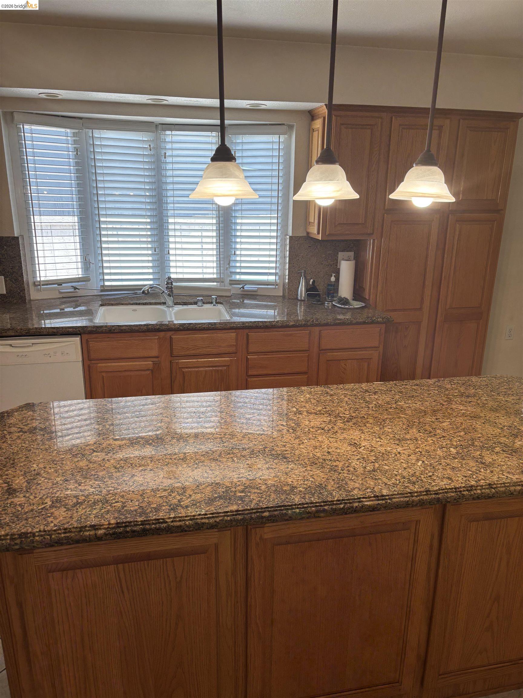 1310 B Street Antioch, CA 94509 - Photo 2 of 7 a bathroom with a granite countertop sink and a large window