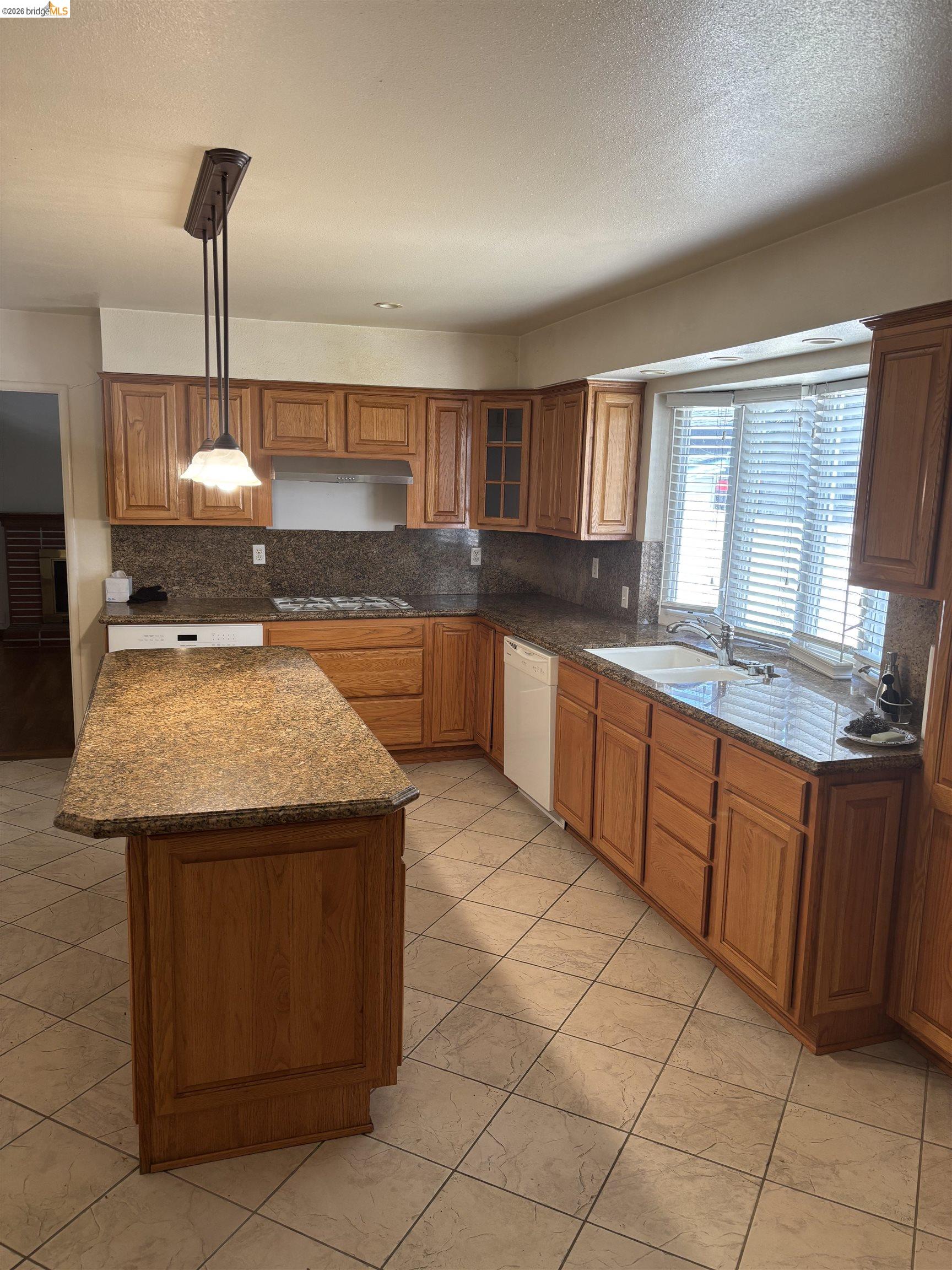 1310 B Street Antioch, CA 94509 - Photo 3 of 7 a kitchen with stainless steel appliances granite countertop a sink stove and cabinets