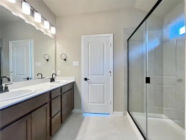 a bathroom with a double vanity sink and mirror