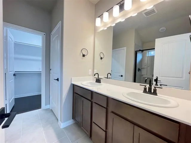 a bathroom with a double vanity sink a and mirror