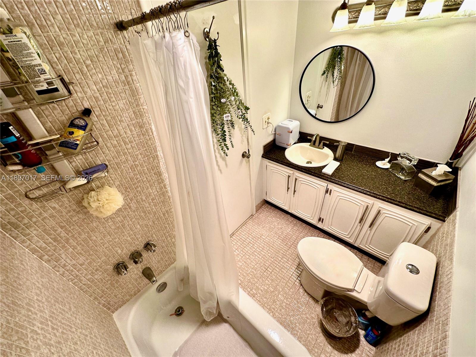 35 Colonial Club Drive, Unit 203 Boynton Beach, FL 33435 - Photo 18 of 29 a bathroom with a sink and a mirror