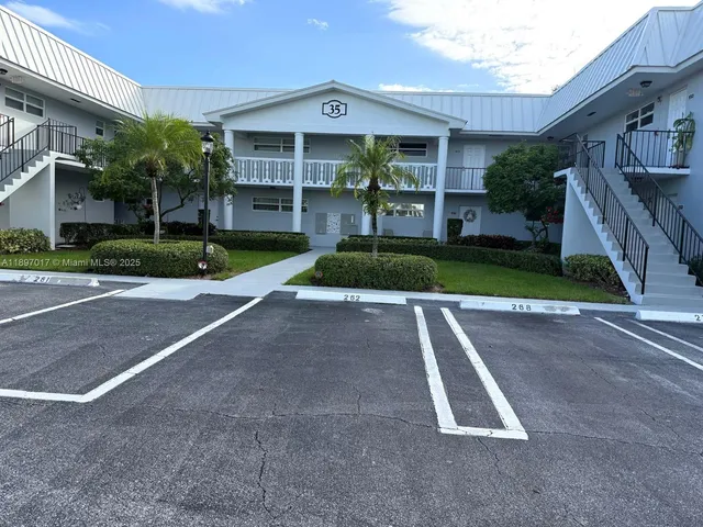 a view of a house with a yard and plants