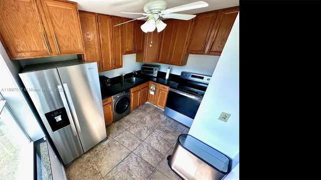 a walk in closet with wooden floor and a rug