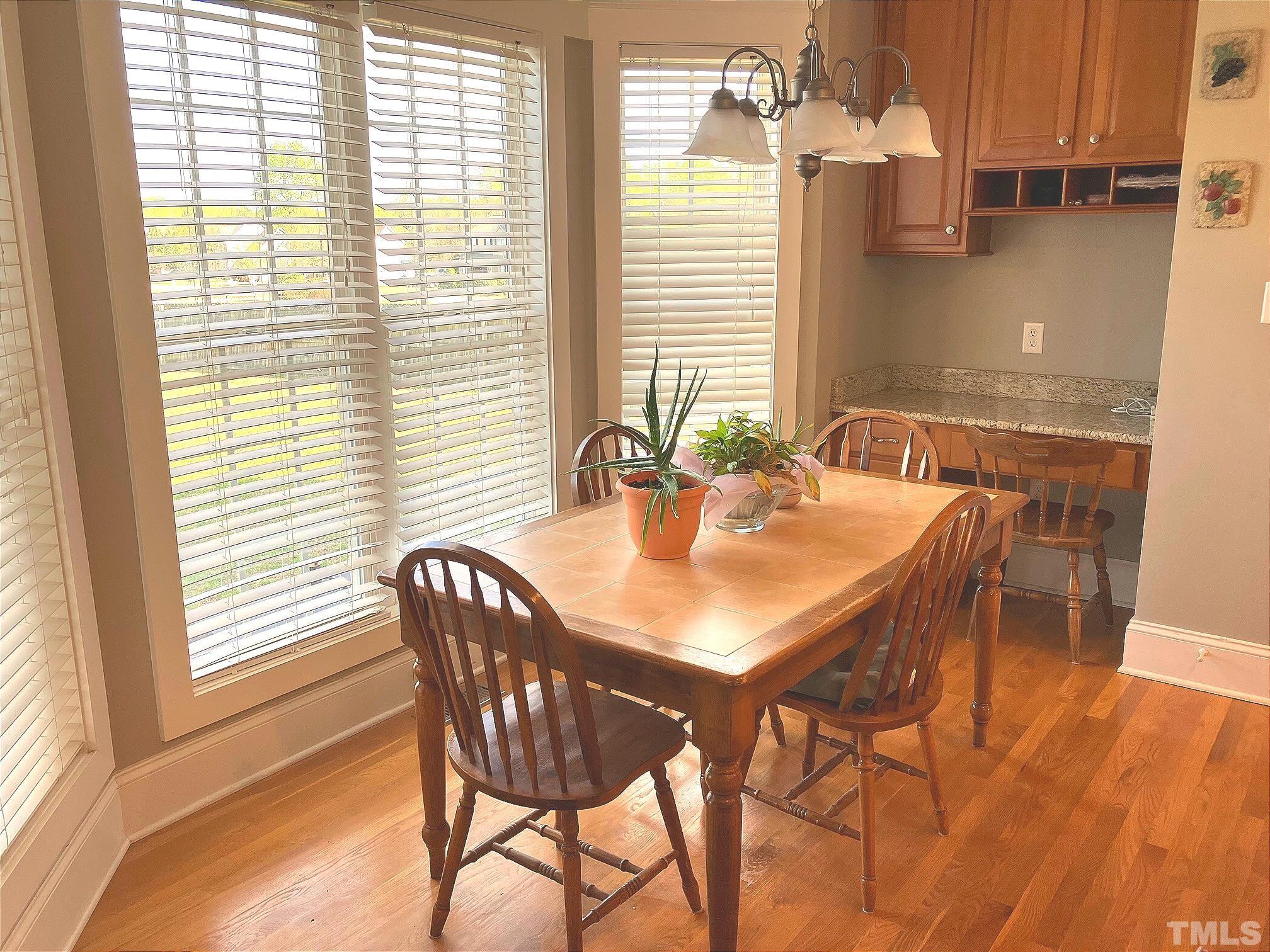 7733 Pegram Street Willow Spring, NC 27592 - Photo 12 of 34 a view of a dining room with furniture and wooden floor