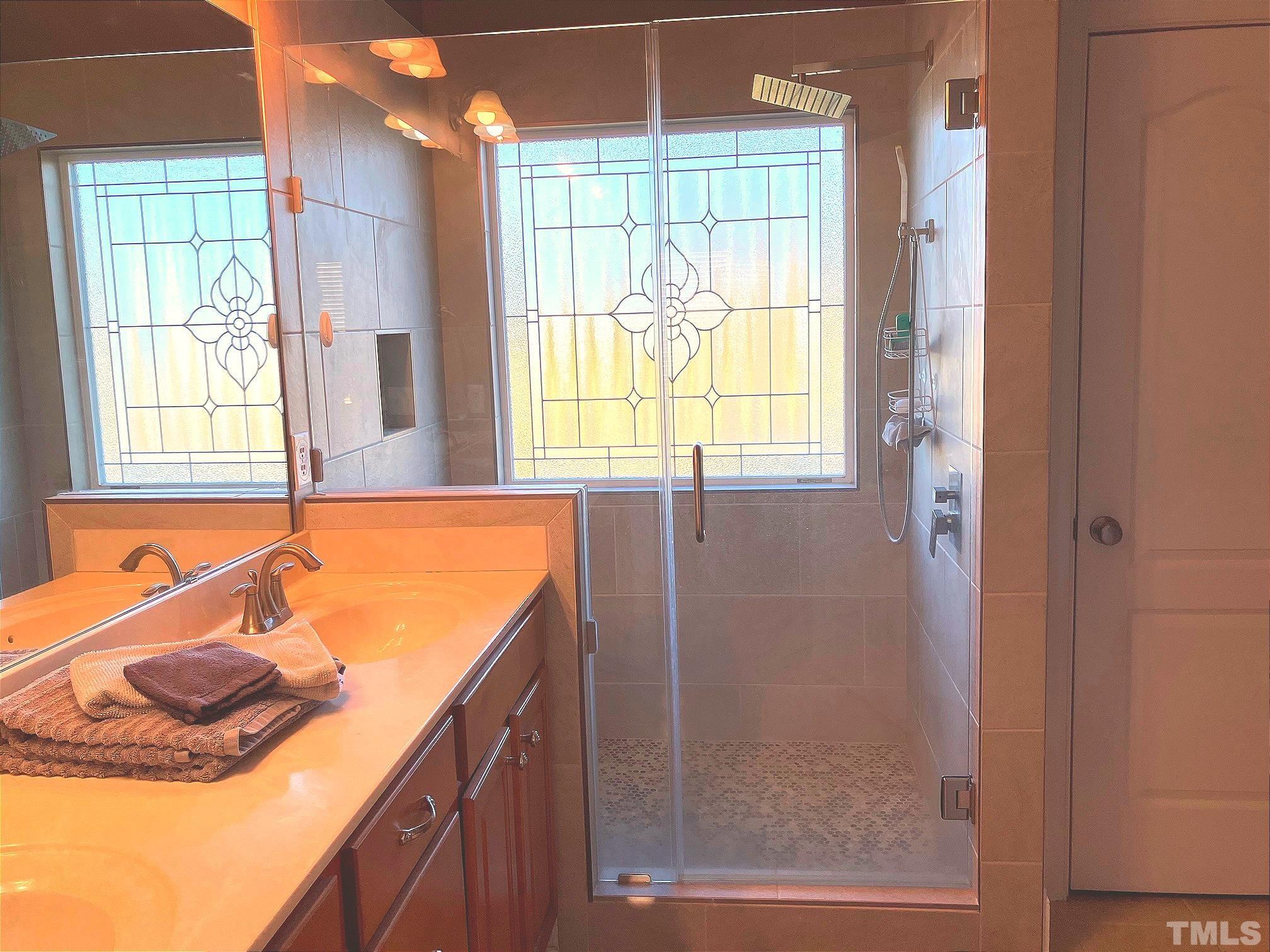 7733 Pegram Street Willow Spring, NC 27592 - Photo 20 of 34 a bathroom with a tub sink and mirror