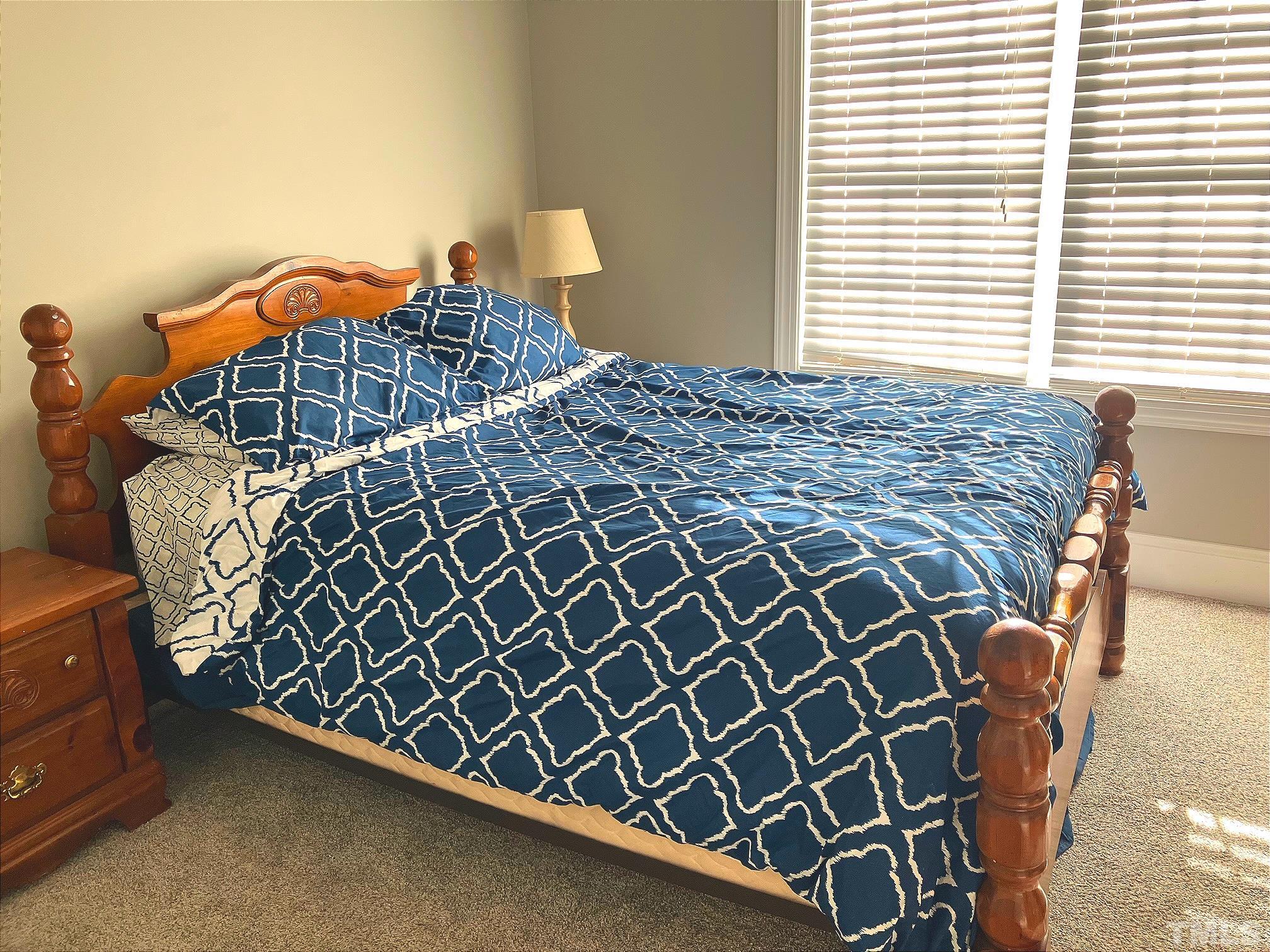 7733 Pegram Street Willow Spring, NC 27592 - Photo 25 of 34 a bed sitting in a bedroom next to a window