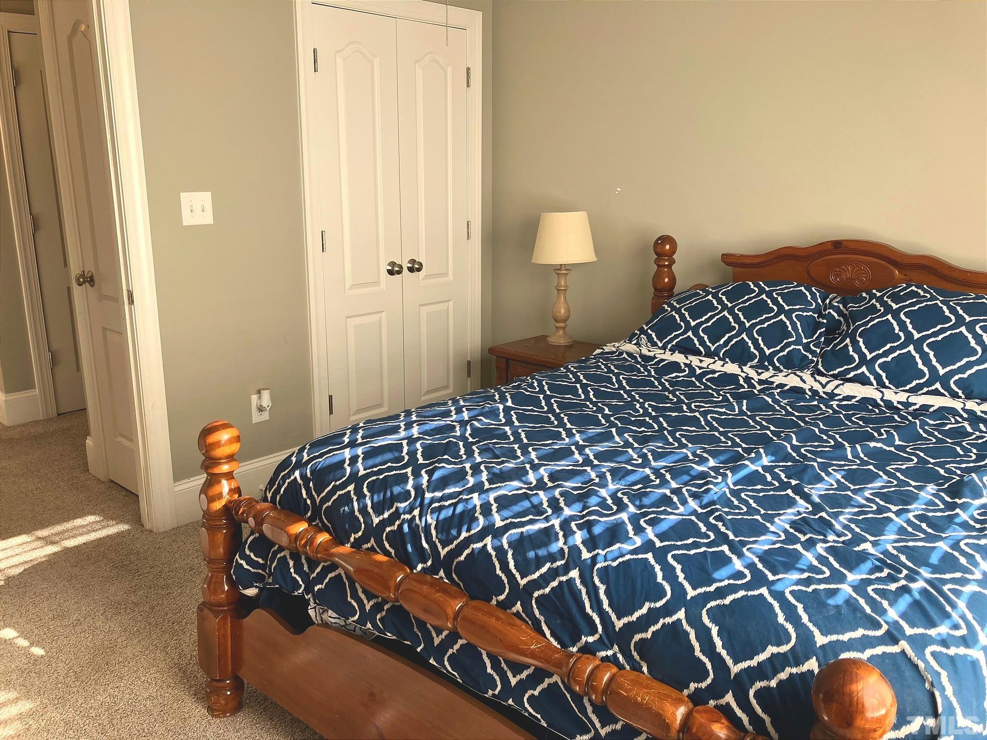 7733 Pegram Street Willow Spring, NC 27592 - Photo 26 of 34 a bedroom with a bed and painting on the wall