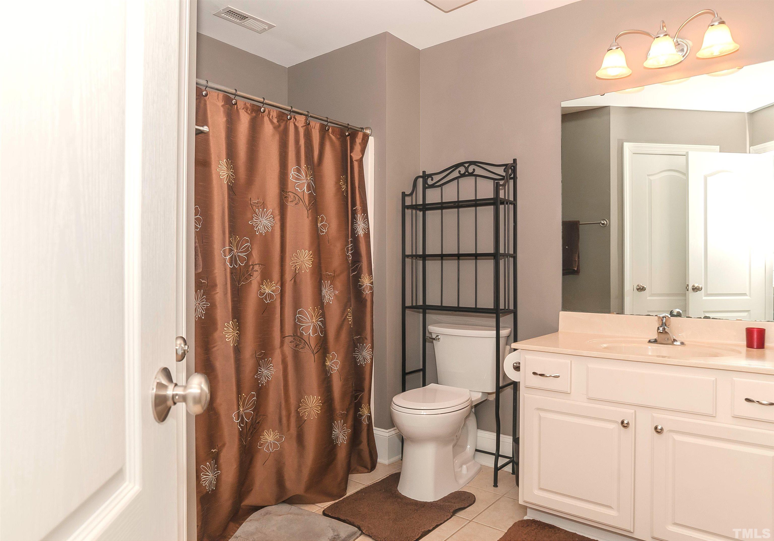 7733 Pegram Street Willow Spring, NC 27592 - Photo 27 of 34 a bathroom with a sink toilet and shower