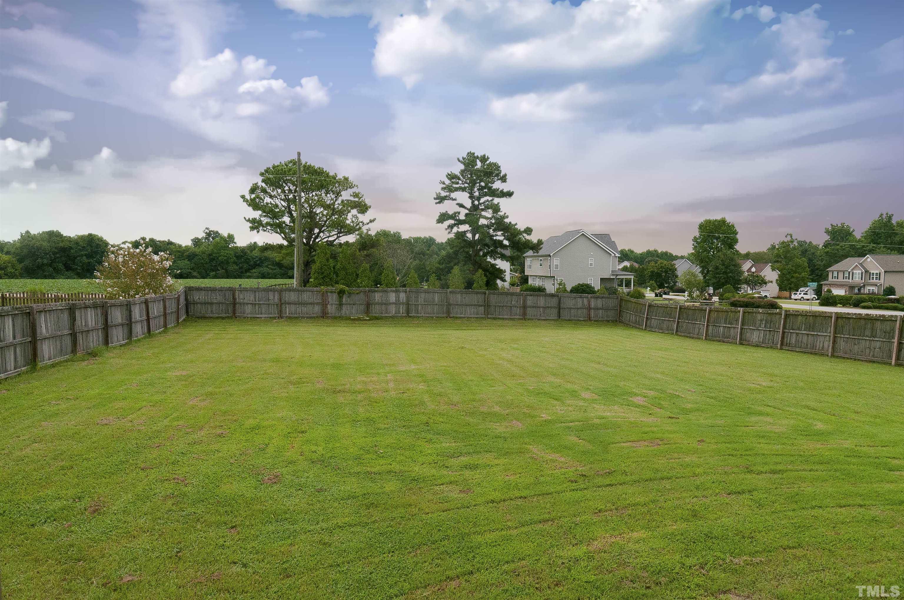 7733 Pegram Street Willow Spring, NC 27592 - Photo 33 of 34 a view of a swimming pool with a yard