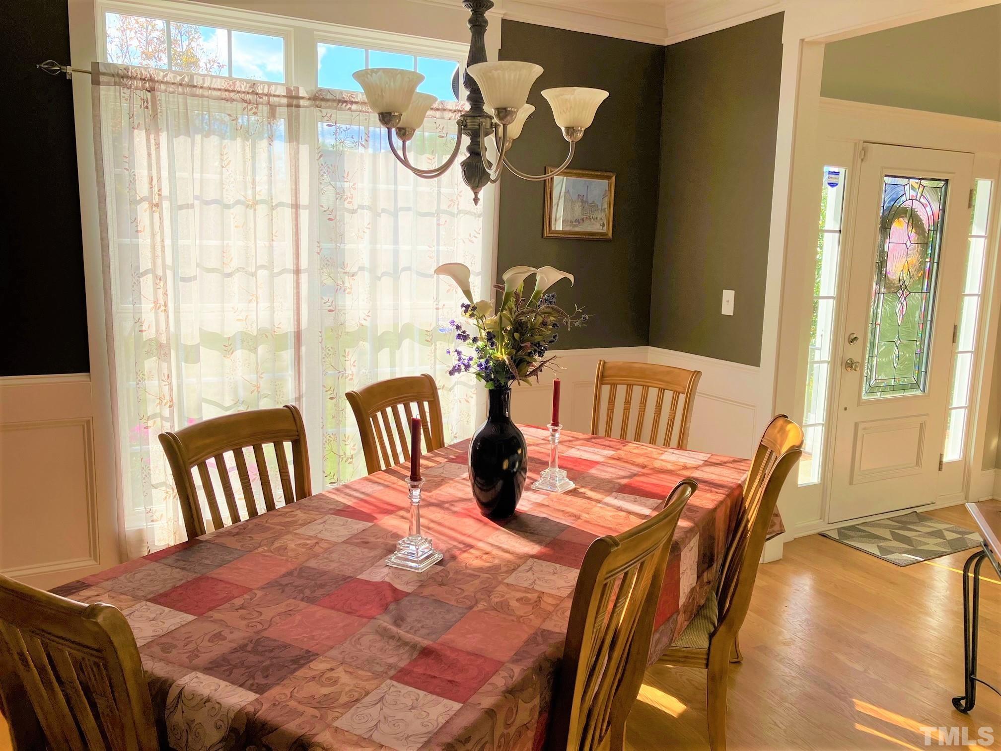 7733 Pegram Street Willow Spring, NC 27592 - Photo 4 of 34 a view of a dining room with furniture and chandelier