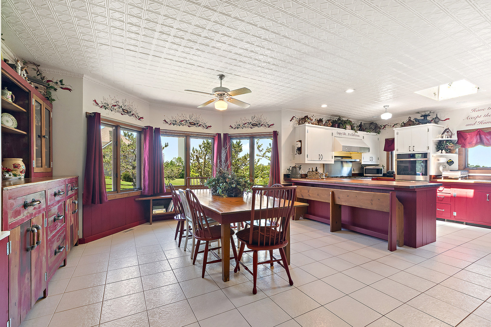 7860 West Steger Road Frankfort, IL 60423 - Photo 19 of 56 a open dining room with stainless steel appliances kitchen island granite countertop a table chairs and a refrigerator