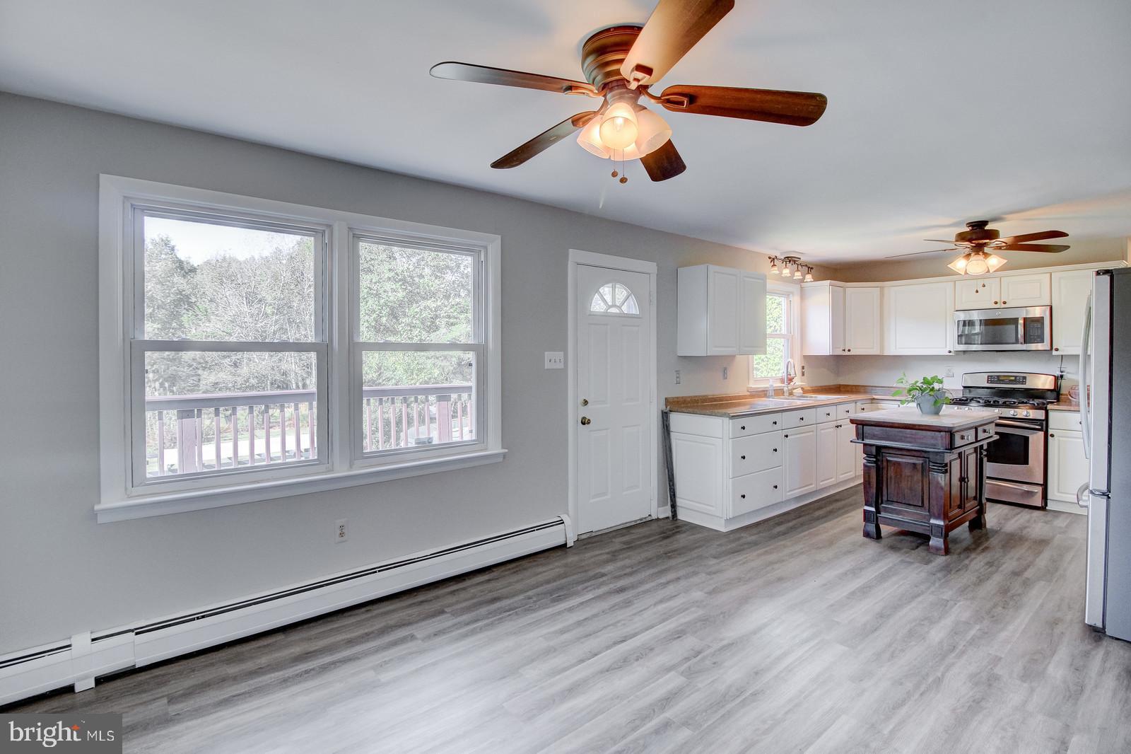 331 Juliustown Road Columbus, NJ 08022 - Photo 14 of 26 a kitchen with stainless steel appliances kitchen island granite countertop a stove a sink and a microwave
