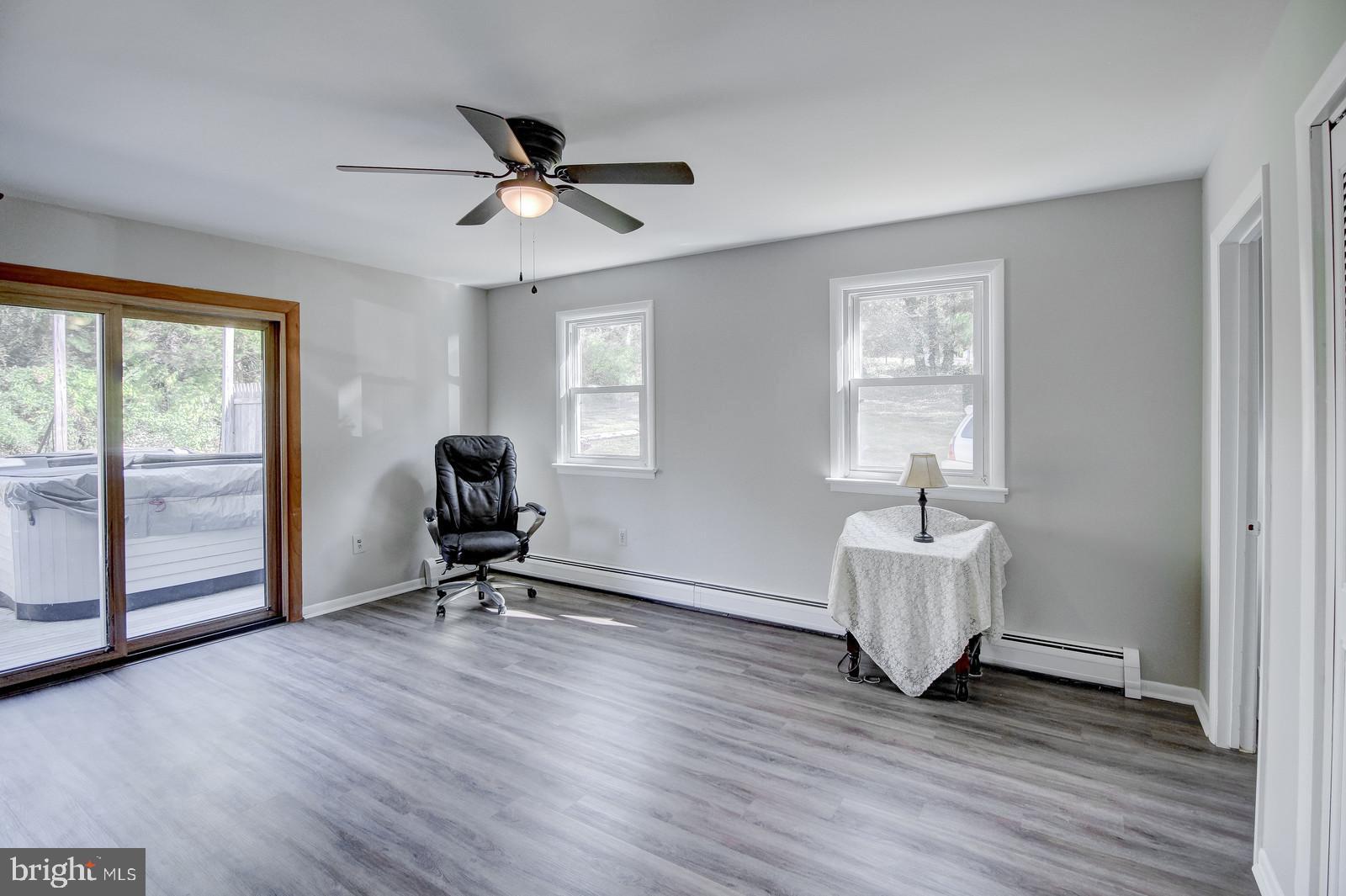 331 Juliustown Road Columbus, NJ 08022 - Photo 15 of 26 a view of a livingroom with wooden floor and a ceiling fan