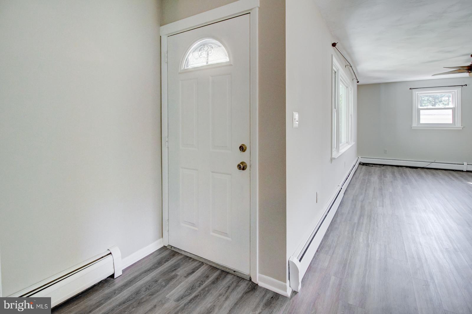 331 Juliustown Road Columbus, NJ 08022 - Photo 4 of 26 an empty room with wooden floor and windows