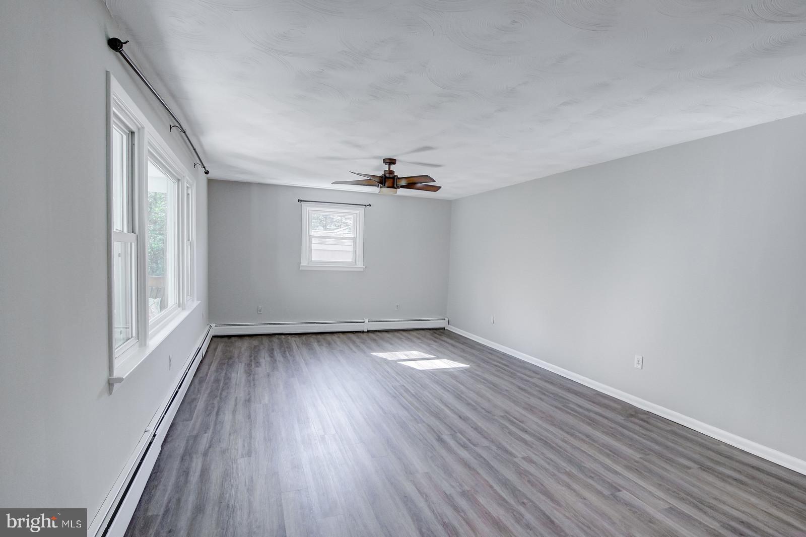 331 Juliustown Road Columbus, NJ 08022 - Photo 5 of 26 an empty room with wooden floor and windows