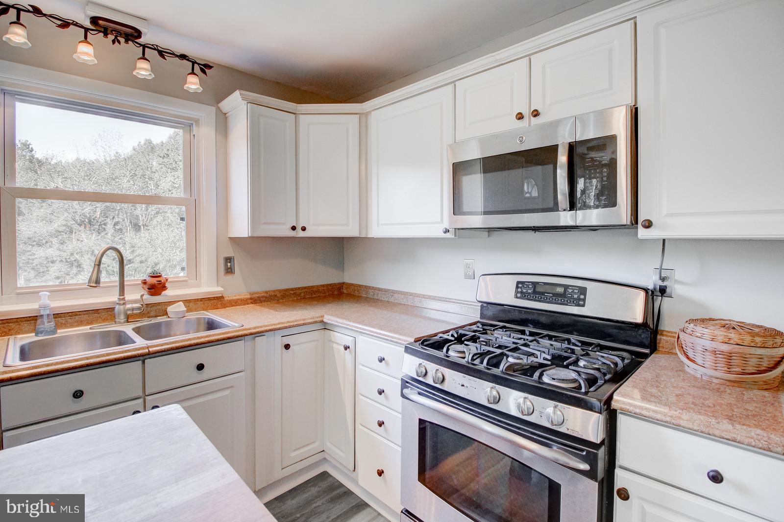 331 Juliustown Road Columbus, NJ 08022 - Photo 9 of 26 a kitchen with cabinets appliances a sink and a window