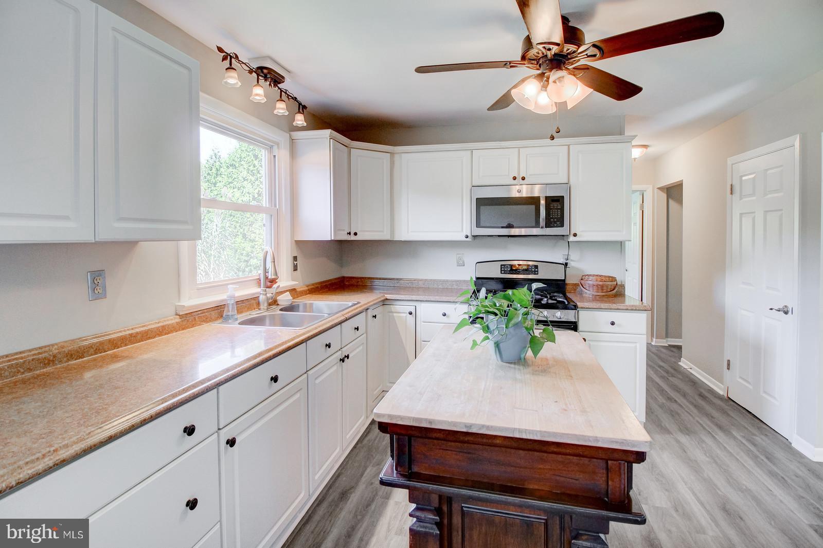 331 Juliustown Road Columbus, NJ 08022 - Photo 10 of 26 a kitchen with a white cabinets and chairs