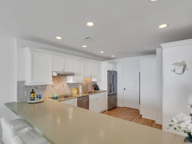 a kitchen with refrigerator and cabinets