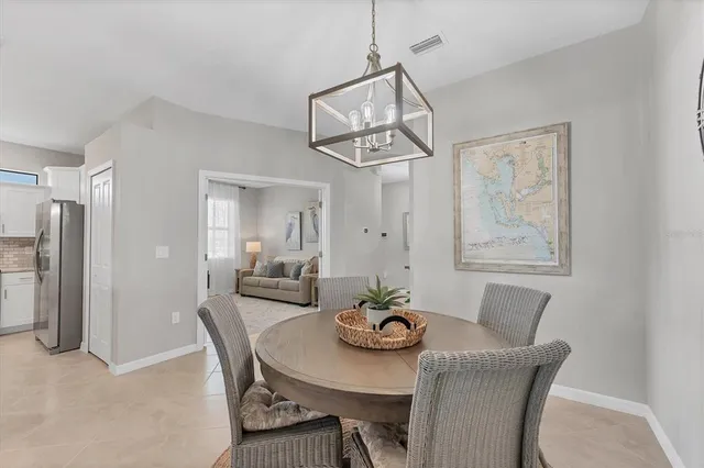 a view of a dining room with furniture and a chandelier