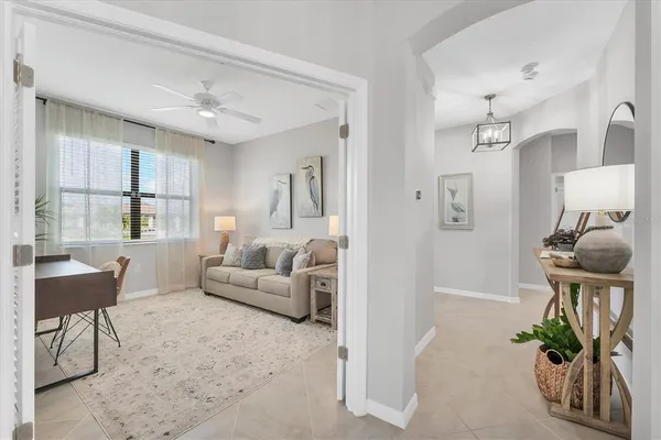 a living room with furniture and a chandelier