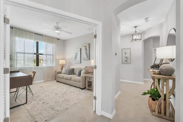 a living room with furniture and a chandelier
