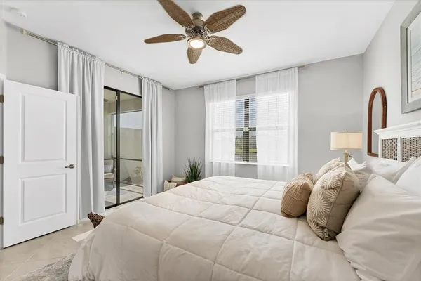 a bedroom with a large bed and a chandelier