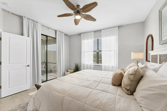 a bedroom with a large bed and a chandelier
