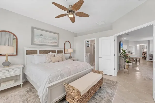 a bedroom with a bed and a chandelier