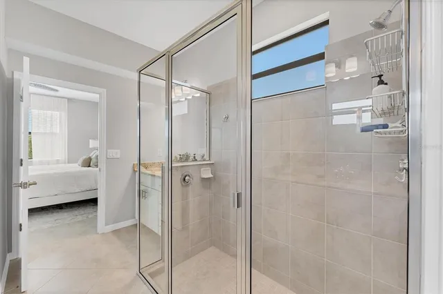 a bathroom with a glass shower door and a bathtub