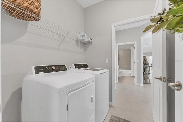 a view of washer and dryer with kitchen in the background