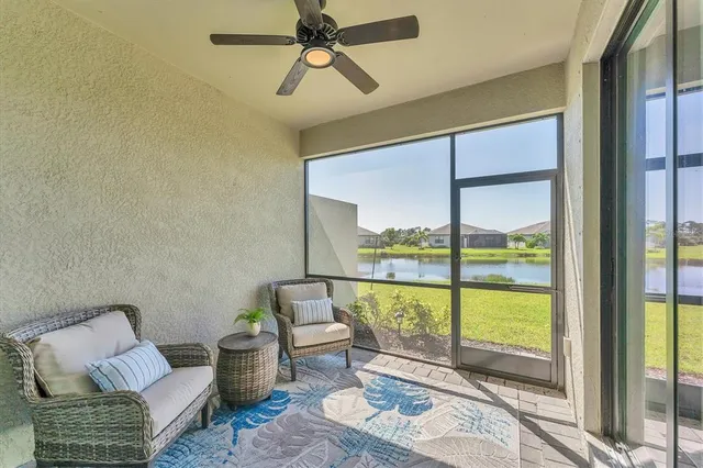 a living room with furniture and a floor to ceiling window