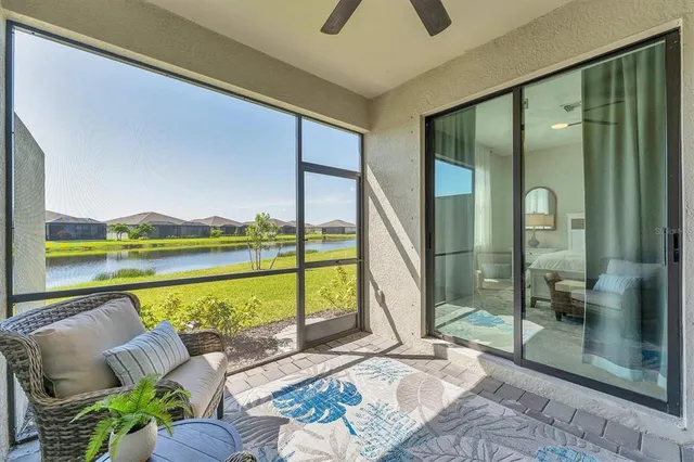 a living room with furniture and a floor to ceiling window