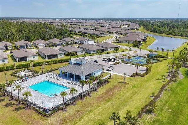 an aerial view of residential houses with outdoor space