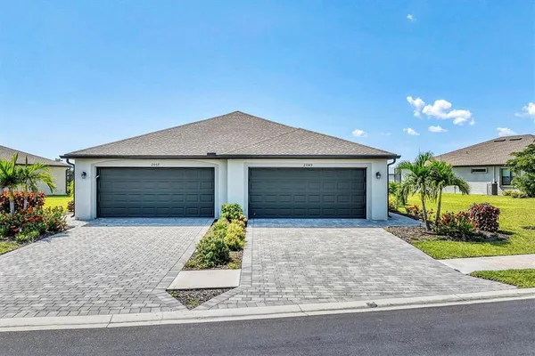 a front view of a house with a yard and garage