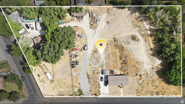 426 North Locust Avenue Lindon, UT 84042 - Photo 3 of 9 Expansive aerial showcasing a significant land parcel featuring a single-story residence with a brown shingle roof, established trees, and a substantial undeveloped area
