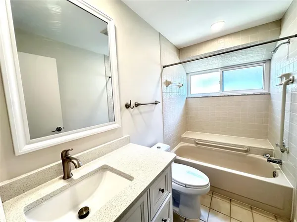 a bathroom with a sink a toilet and a bathtub