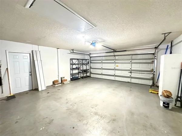 a view of room with stairs and a refrigerator