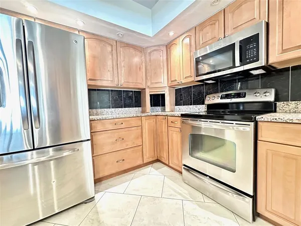 a kitchen with stainless steel appliances a stove microwave and cabinets