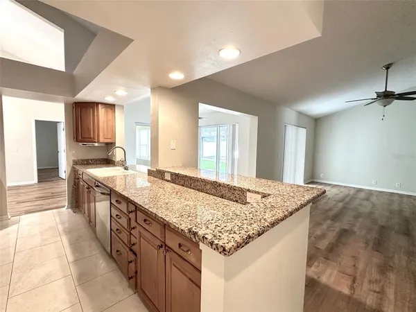 a spacious bathroom with a granite countertop sink and a large mirror