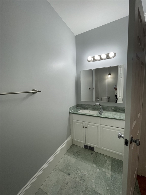 486 Shawmut Avenue, Unit 1 Boston, MA 02118 - Photo 4 of 11 a bathroom with a sink and a mirror